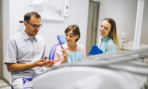 Dentists consulting female patient
