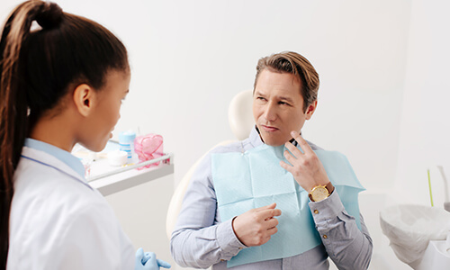Dentist consulting patient with toothache